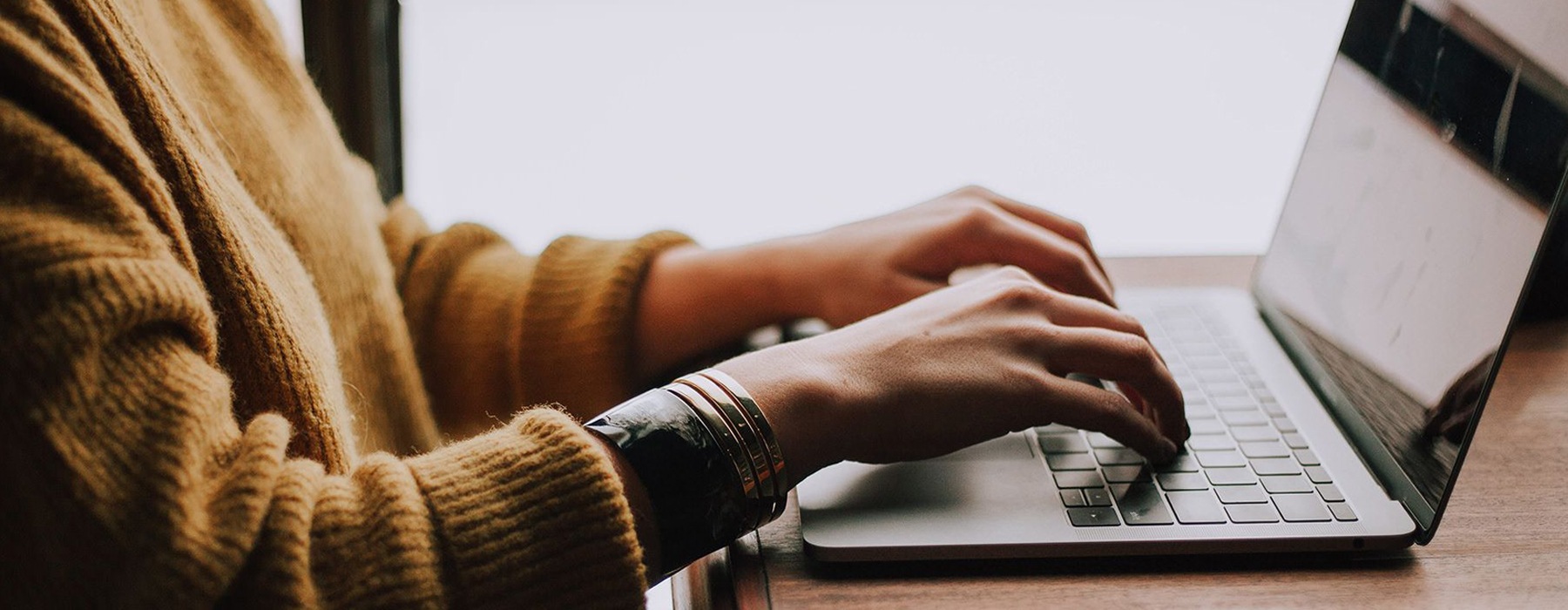 a woman on a laptop typing